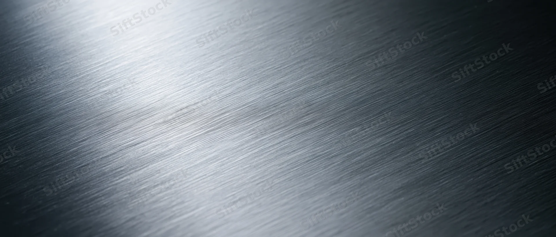 Brushed metal surface with diagonal texture and light gradient