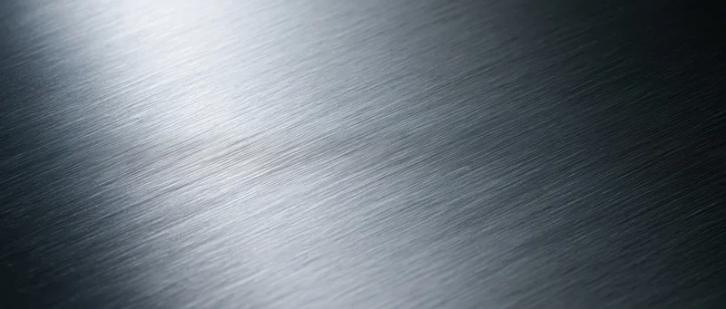 Brushed metal surface with diagonal texture and light gradient