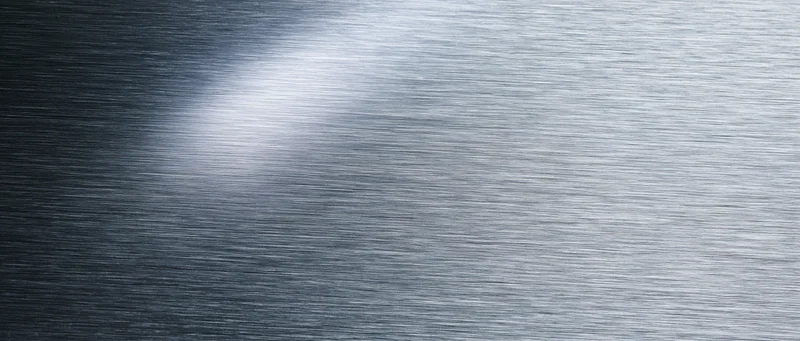 Brushed metal surface with horizontal texture and reflective sheen