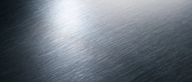 Brushed metal surface with diagonal texture and reflective sheen