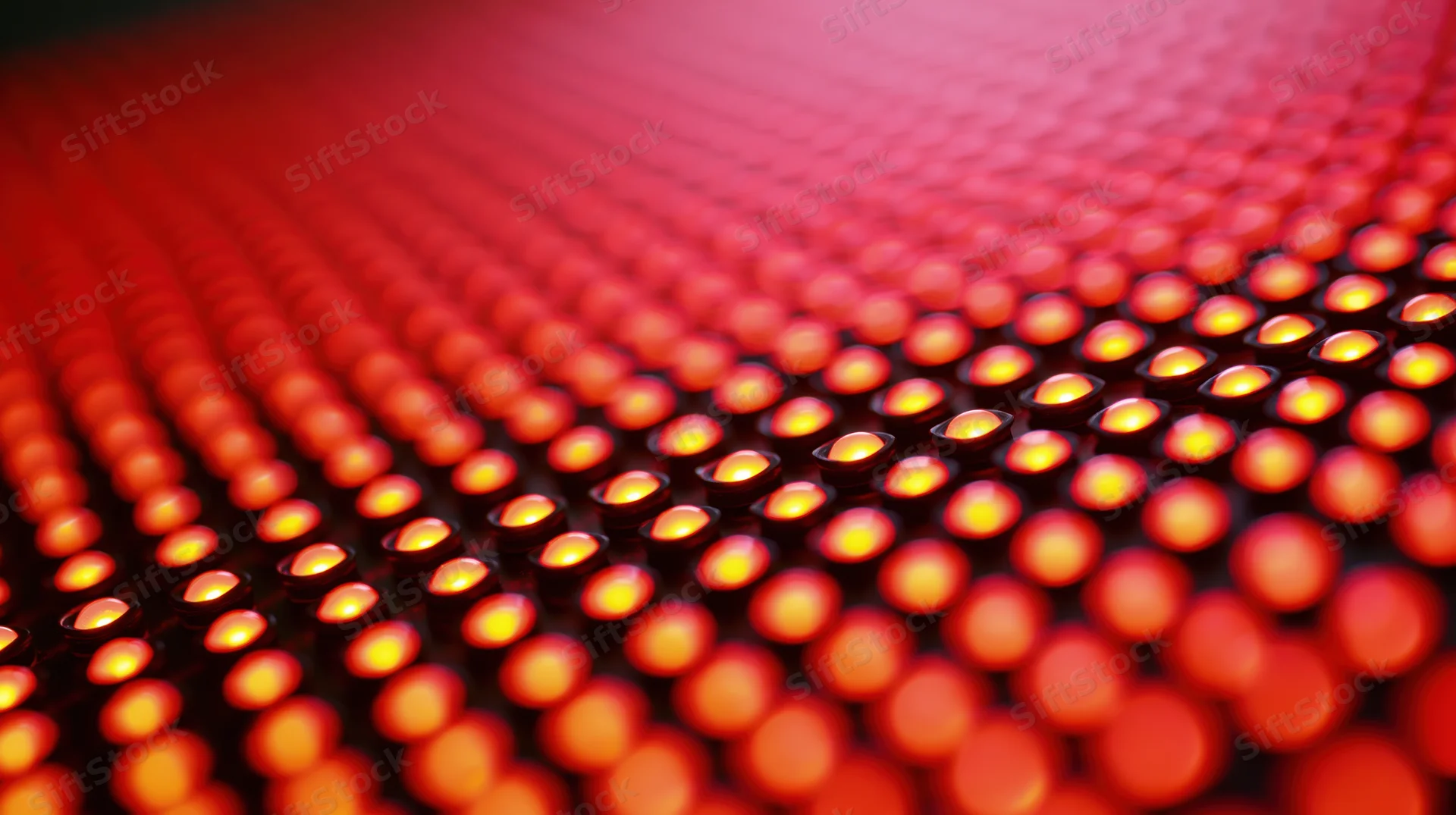 Red led lights arranged in a grid pattern on a curved surface, glowing warmly in close-up view