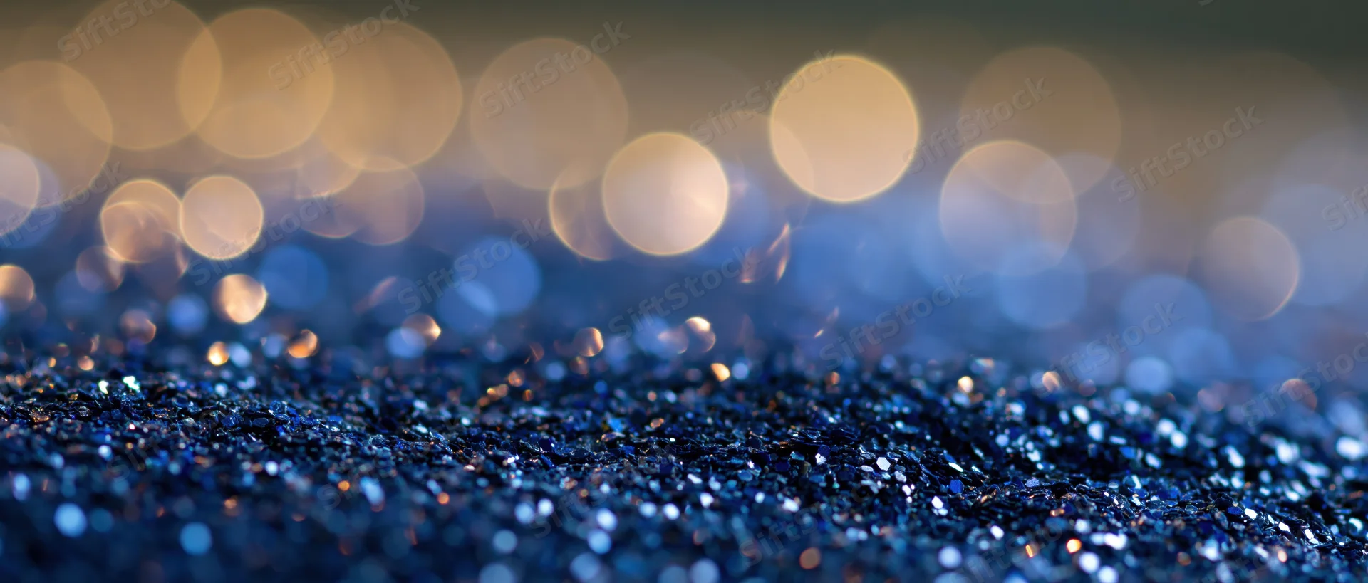 Blue glitter surface with bokeh lights in background