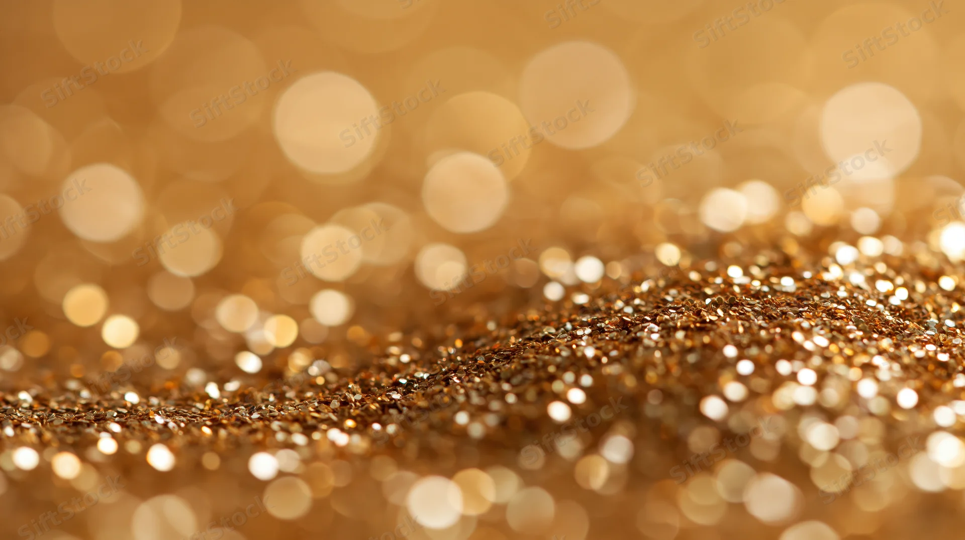Golden glitter texture with bokeh lights in the background