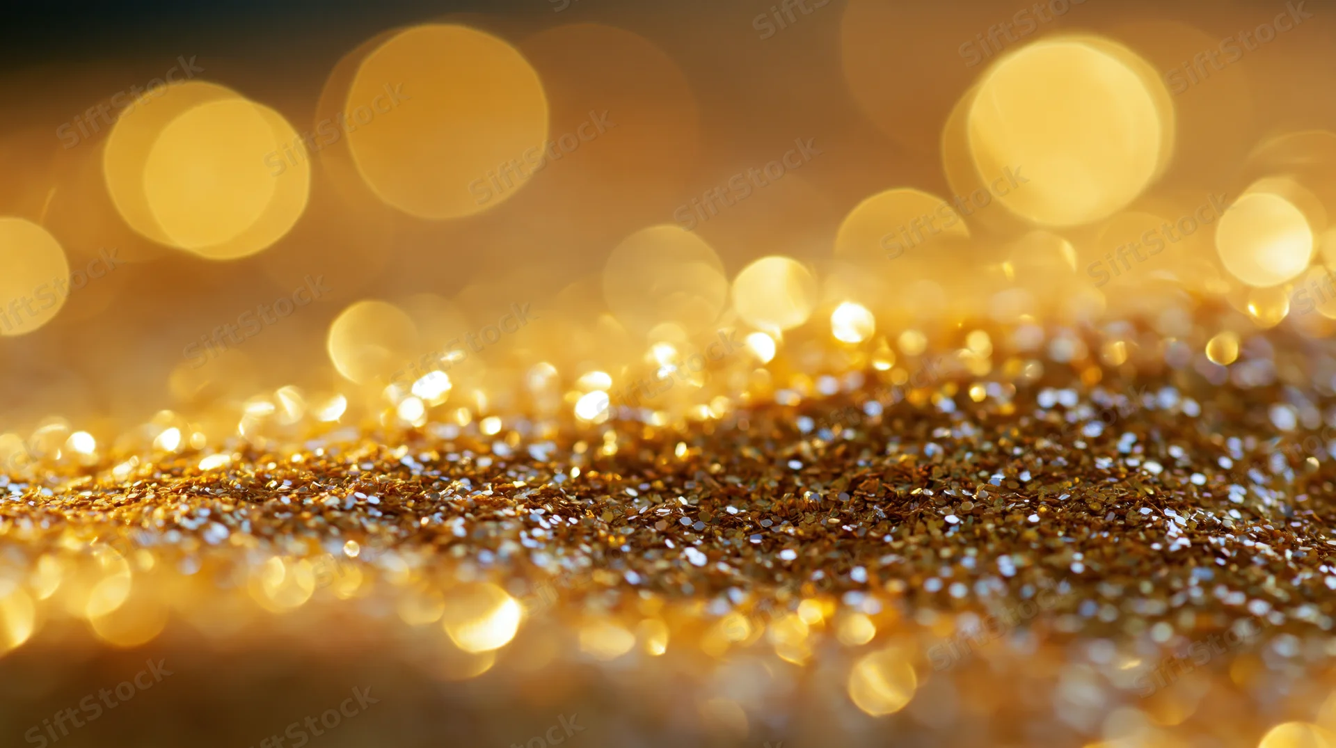 Golden glitter texture with bokeh lights in shallow focus, creating a festive background with copyspace