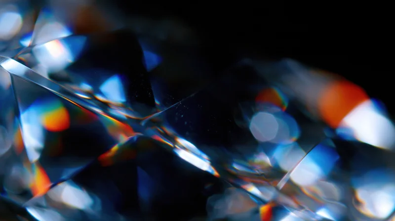 Faceted crystal refracting light into rainbow colors against dark background