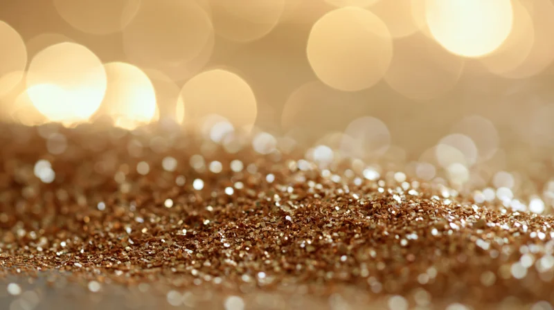 Golden glitter texture with bokeh lights in background