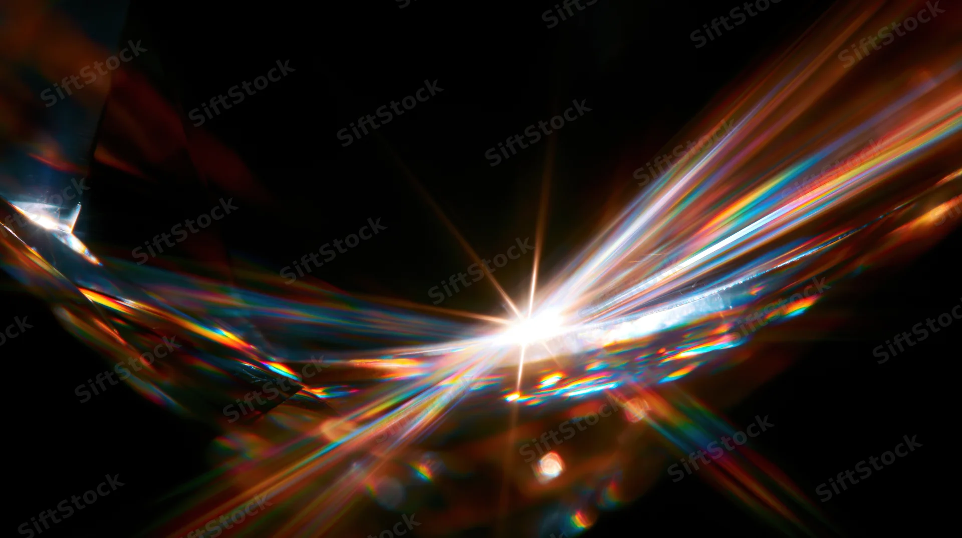 Bright light burst with colorful streaks and lens flare effects against dark background