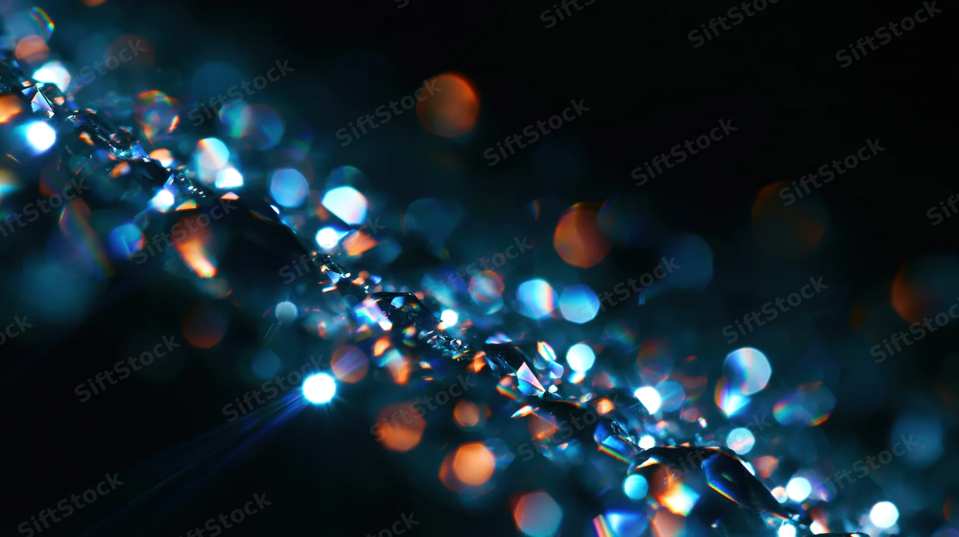 A row of faceted crystals reflecting blue and orange light against a dark background with bokeh effects