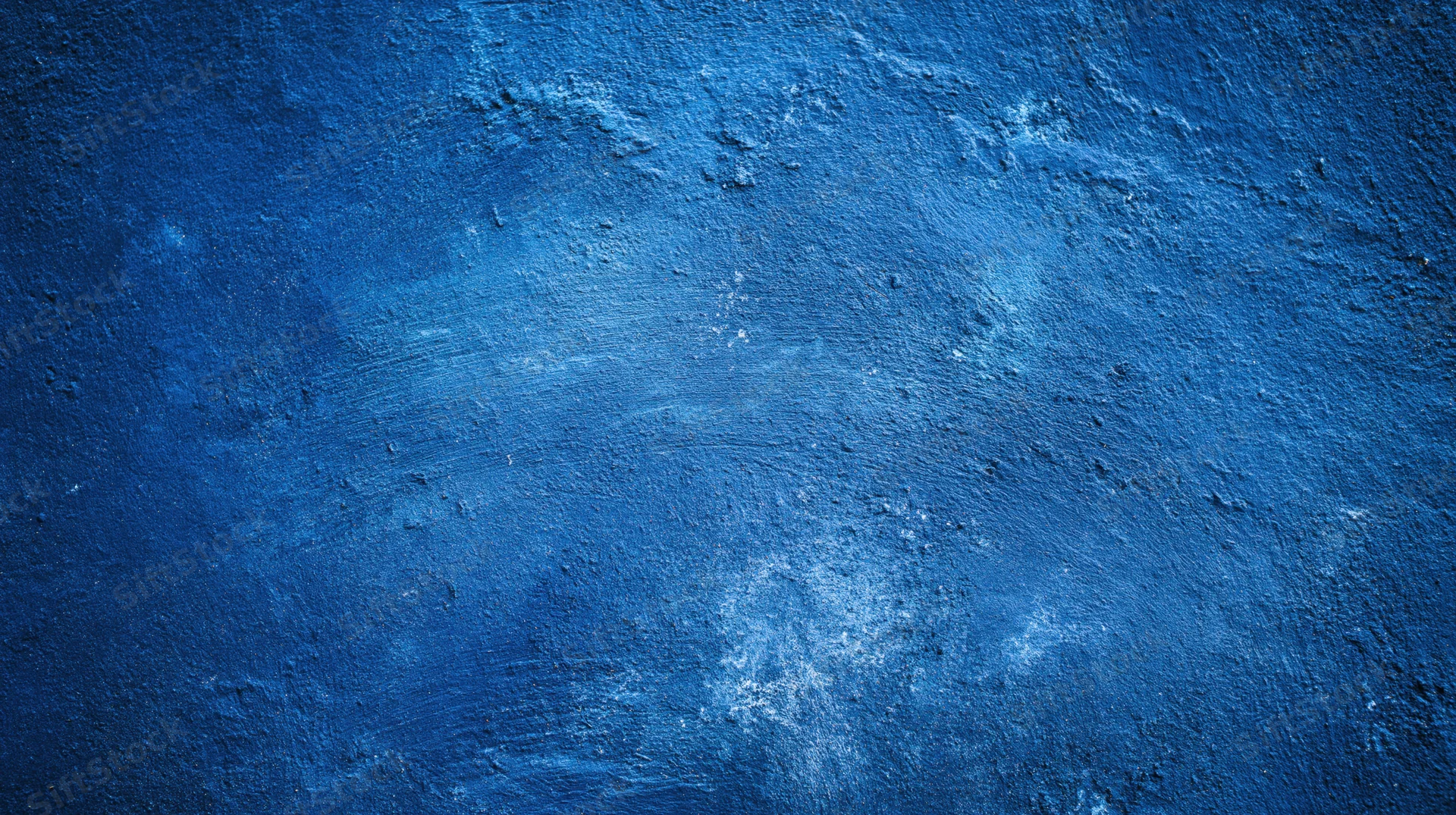 Textured blue painted wall surface with distressed and weathered finish
