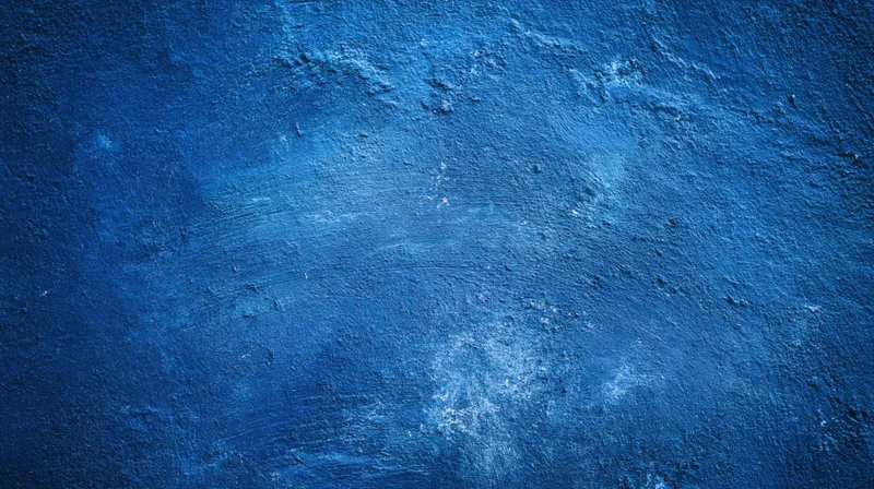 Textured blue painted wall surface with distressed and weathered finish
