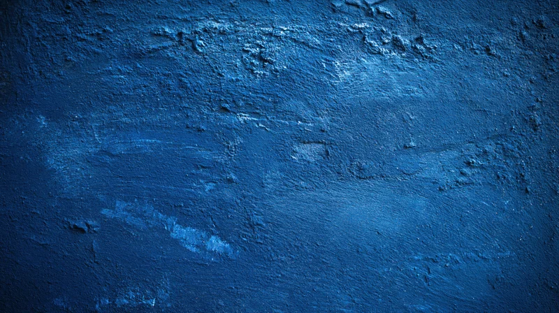 Textured blue painted concrete wall surface with rough uneven finish