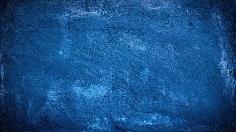 Textured blue painted wall surface with grunge finish and visible wear