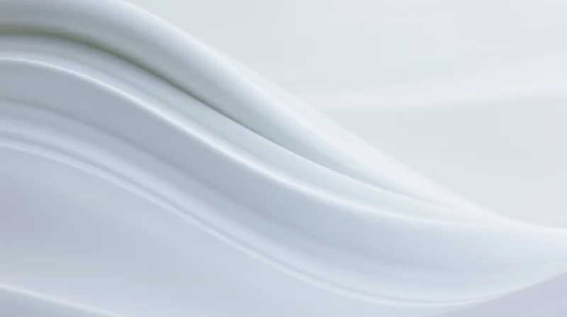 Smooth white flowing waves forming a glossy abstract surface