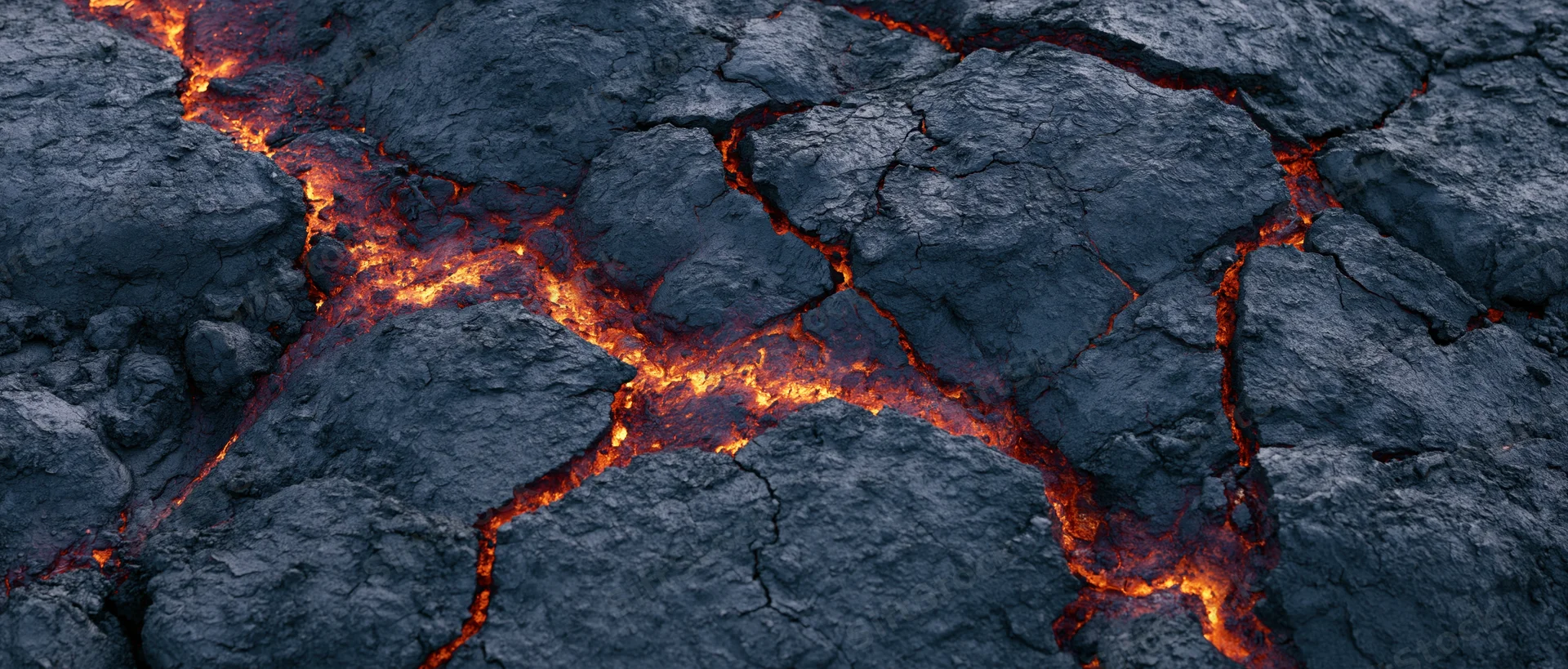 Molten lava flowing through cracks in cooled volcanic rock surface