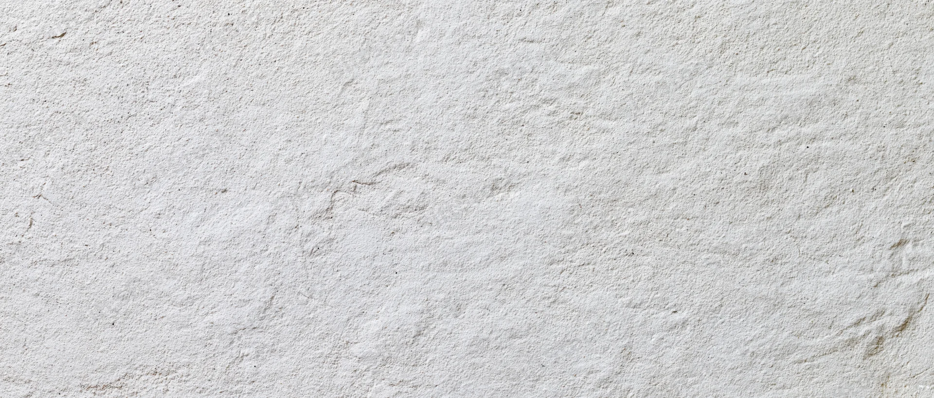 Close-up of a white textured plaster wall surface