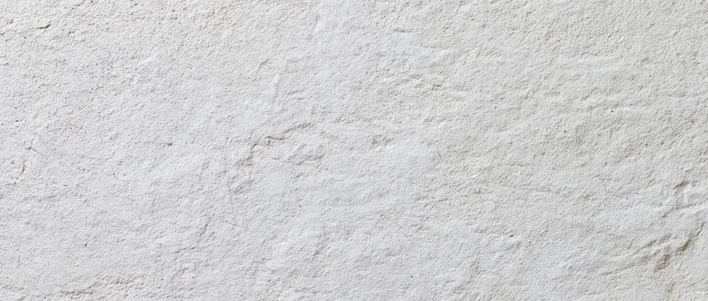 Close-up of a white textured plaster wall surface