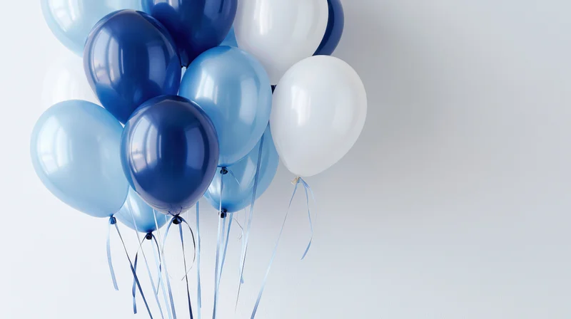 Cluster of blue and white balloons floating against a plain background with copyspace