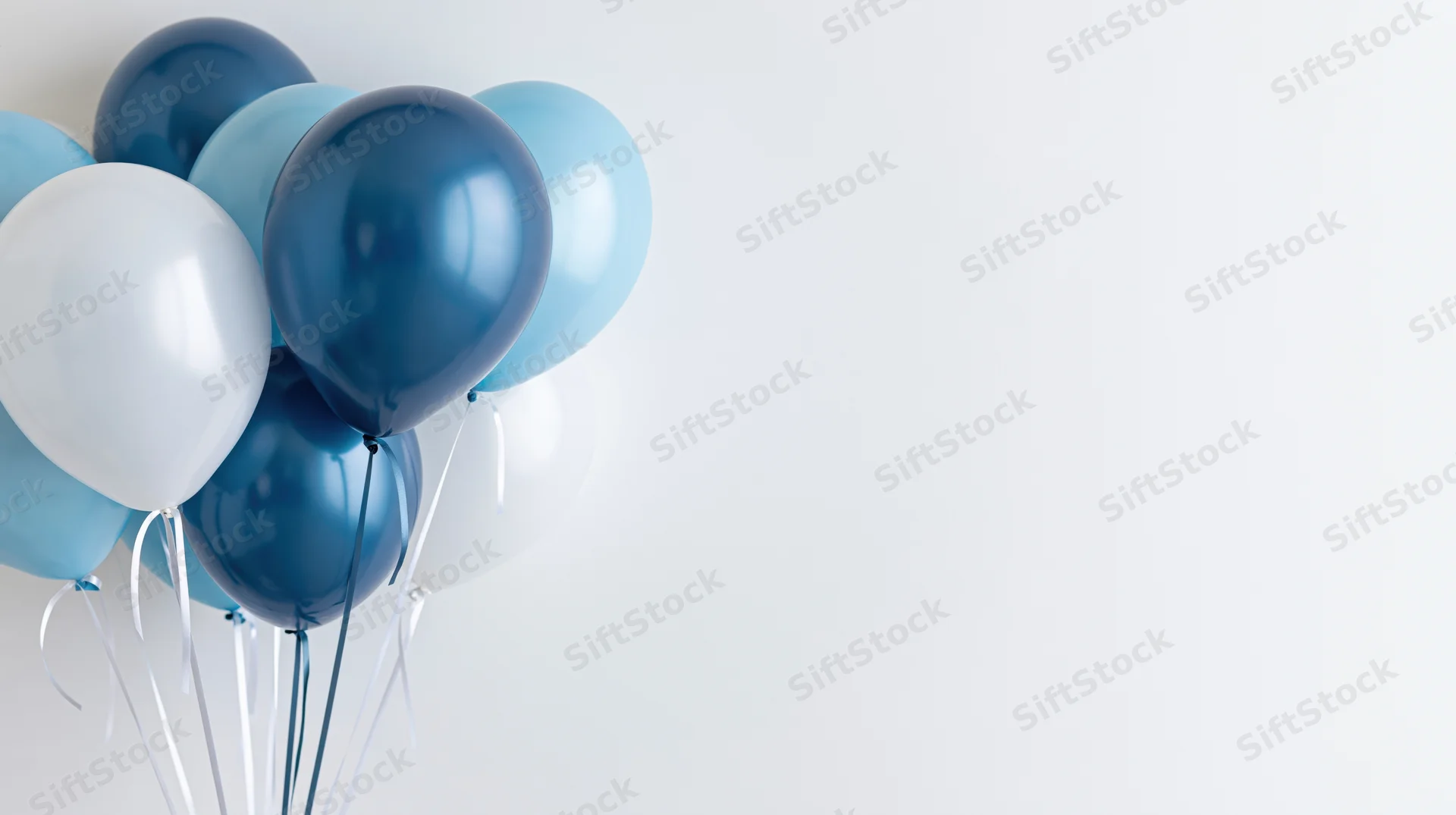 Cluster of blue and white balloons floating against a plain white background with copyspace