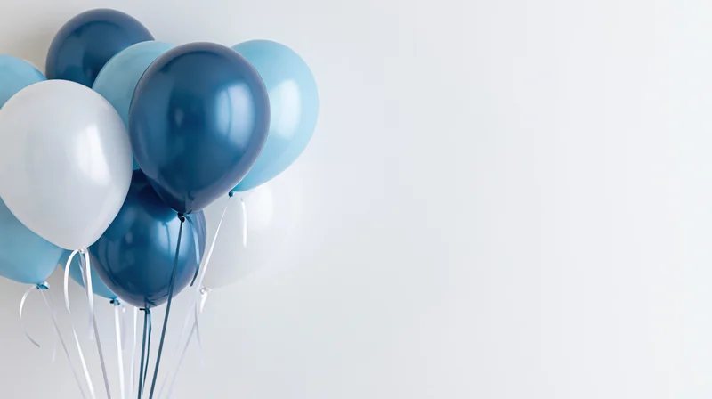 Cluster of blue and white balloons floating against a plain white background with copyspace