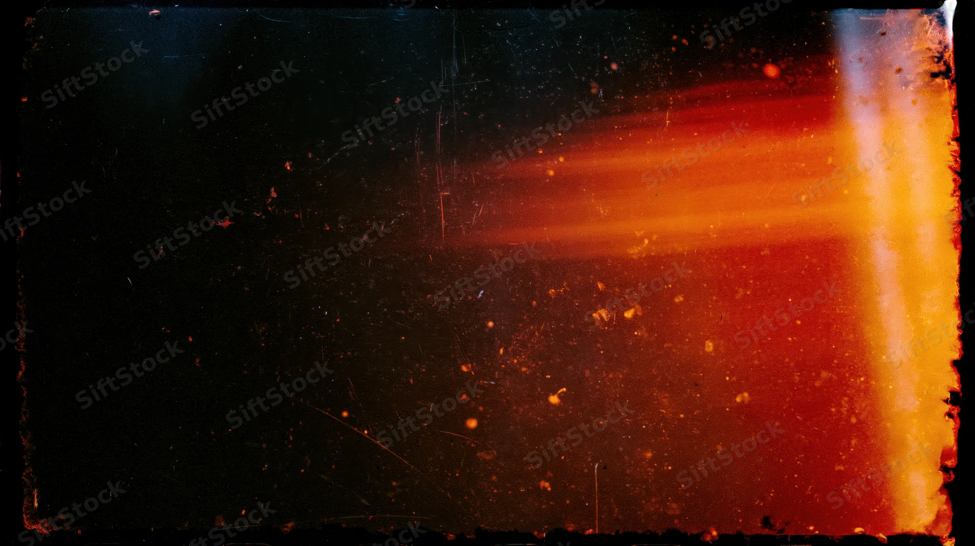 Abstract light flare with orange and red glow and scattered particles on dark background