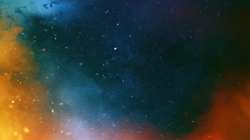 A nebula glowing with blue and orange gas clouds scattered with stars in deep space