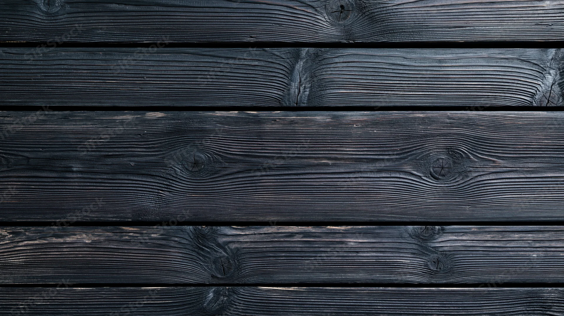 Horizontal black charred wood planks arranged as a textured surface