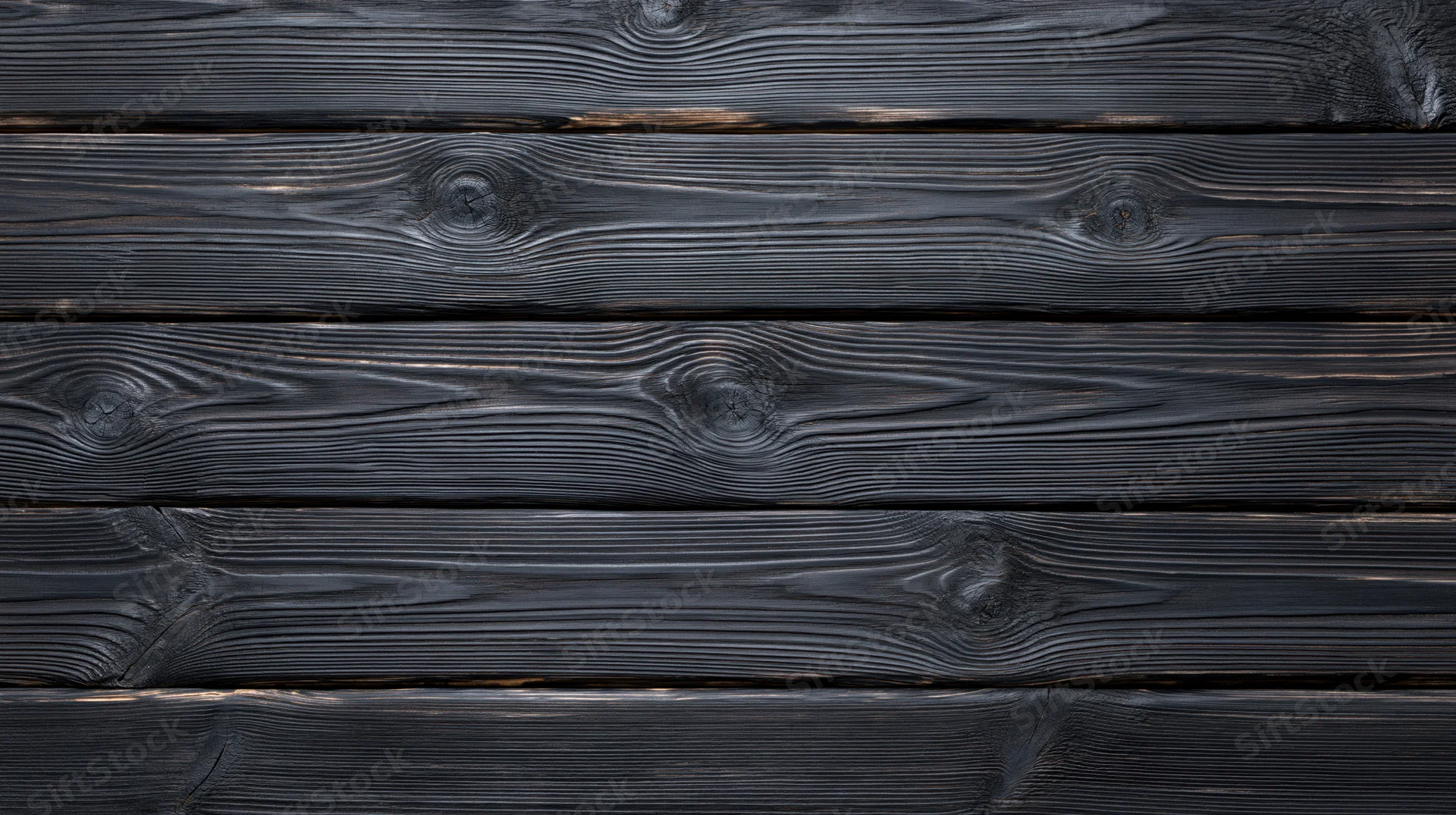 Horizontal black charred wood planks arranged as a textured surface