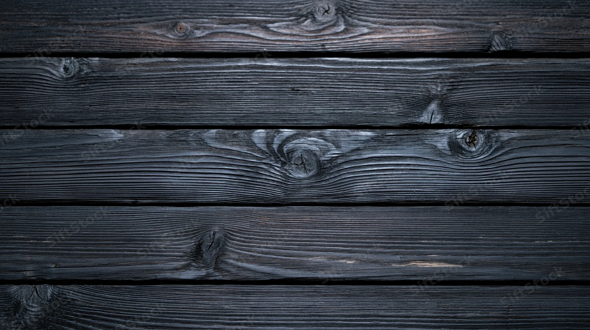 Dark charred wooden planks arranged horizontally as a textured surface