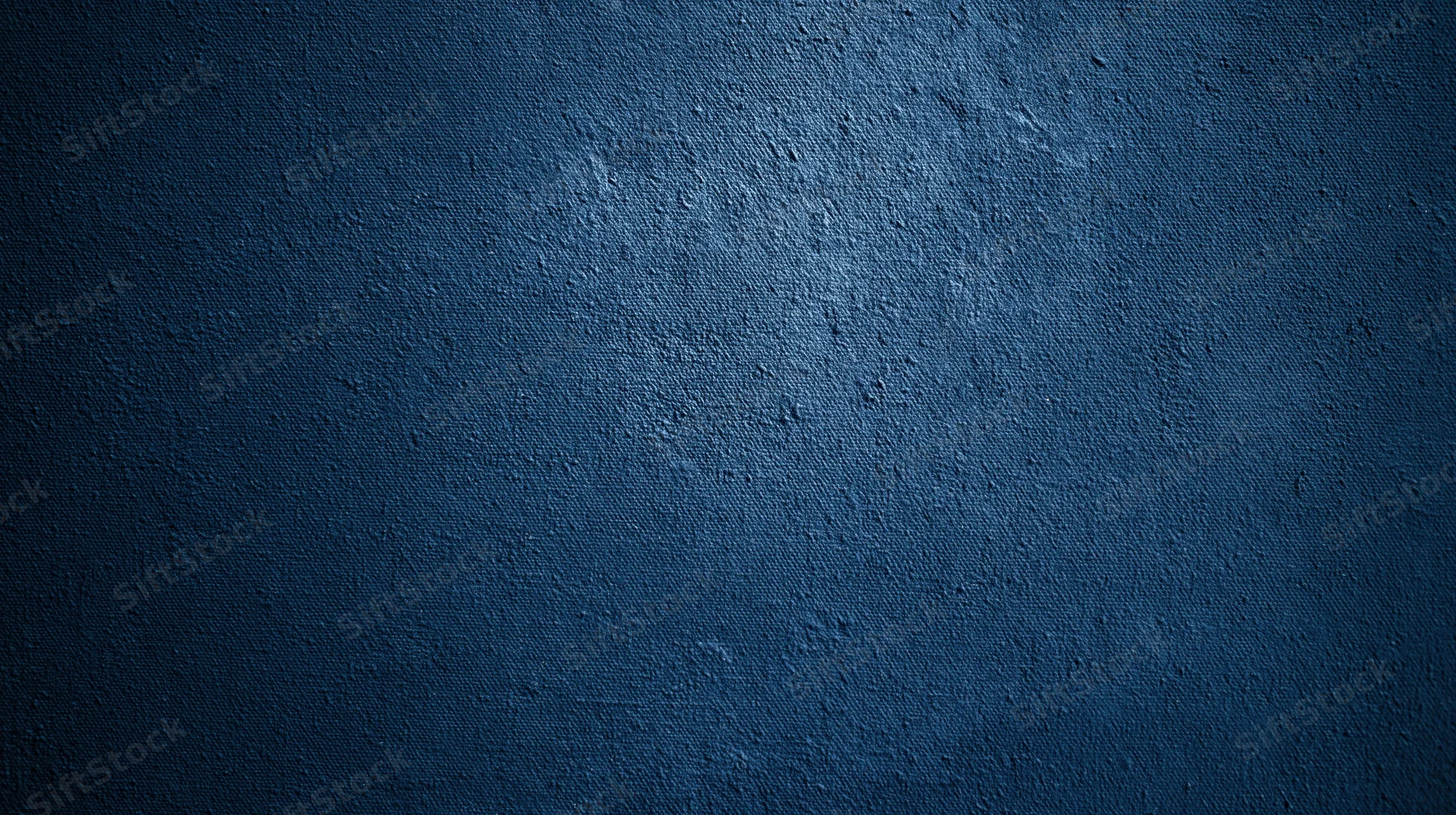 Dark blue textured fabric surface with subtle lighting gradient and visible weave pattern