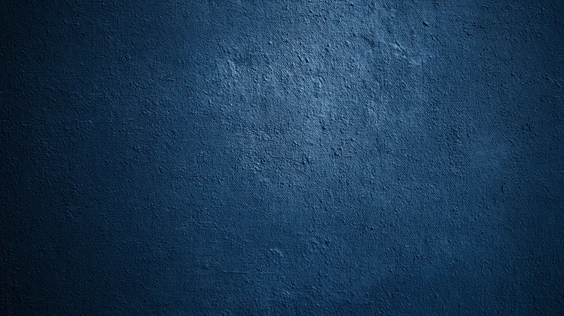 Dark blue textured fabric surface with subtle lighting gradient and visible weave pattern