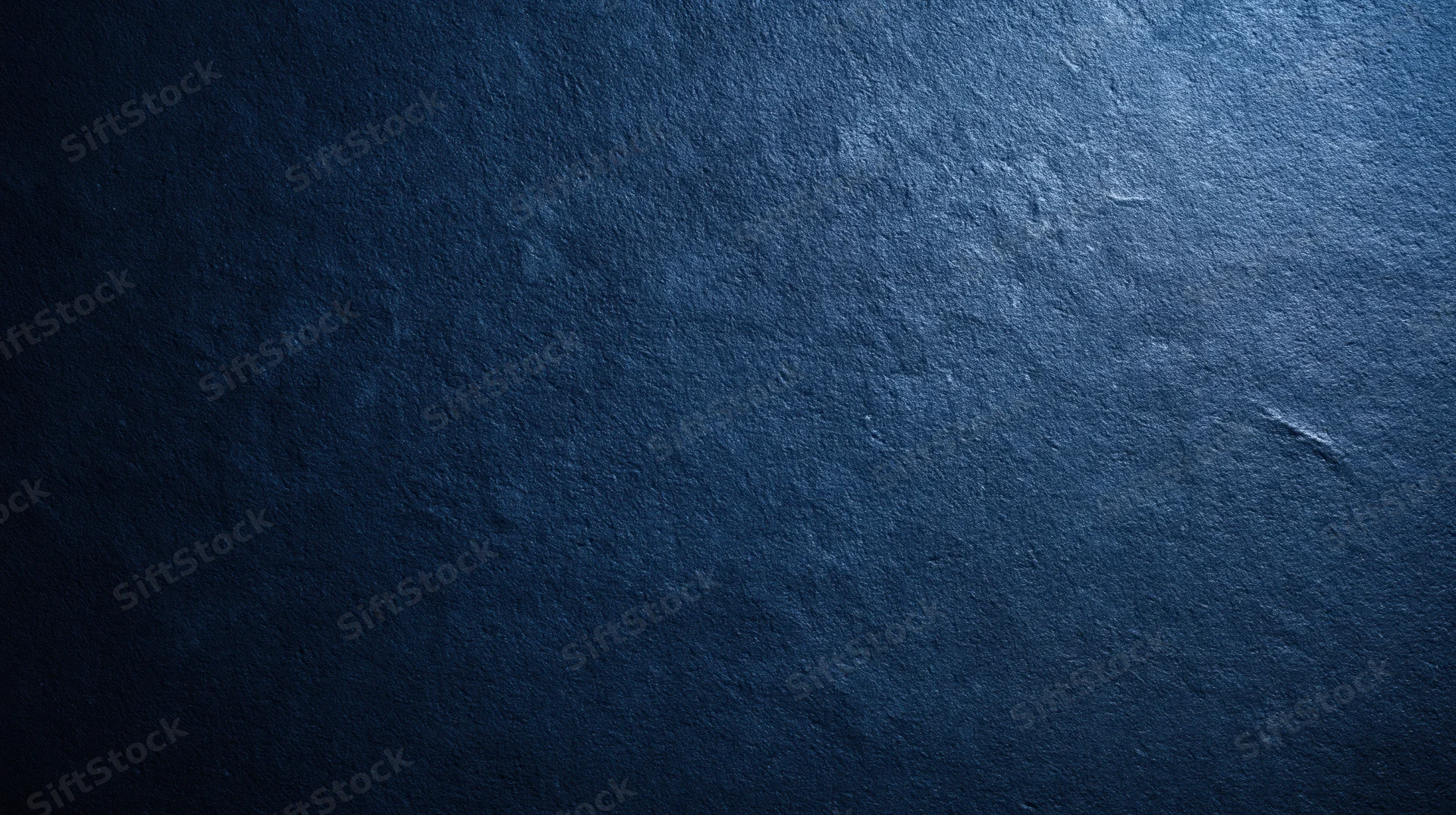 Dark blue textured stone surface with subtle gradient and copyspace