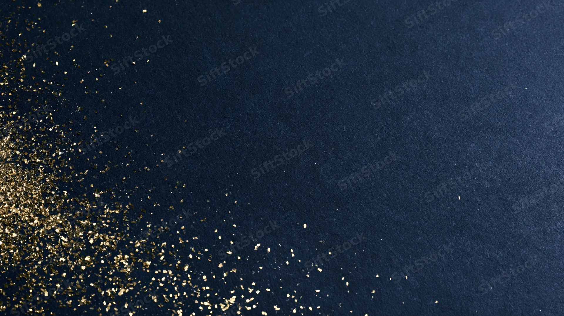 Gold glitter scattered diagonally across navy textured background with copyspace