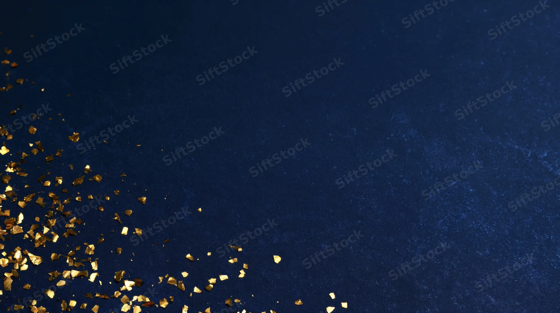 Gold confetti scattered across navy blue textured background with copyspace in upper right