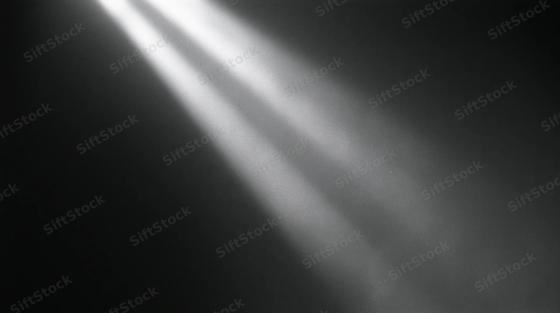 Diagonal beams of light cutting through dark space with soft haze and contrast