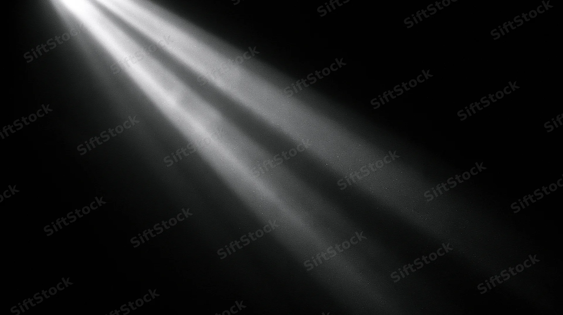 Beams of light cutting through darkness in a dark space