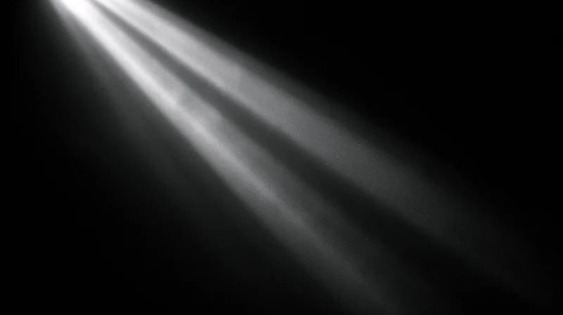 Beams of light cutting through darkness in a dark space