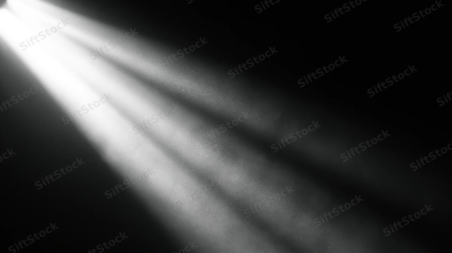 Beams of light cutting through dark space with visible dust particles suspended in air