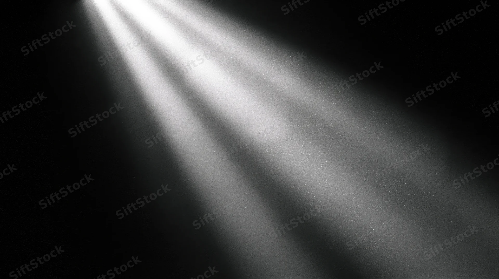 Beams of light cutting through darkness in a studio setting
