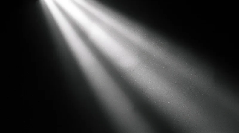 Beams of light cutting through darkness in a studio setting