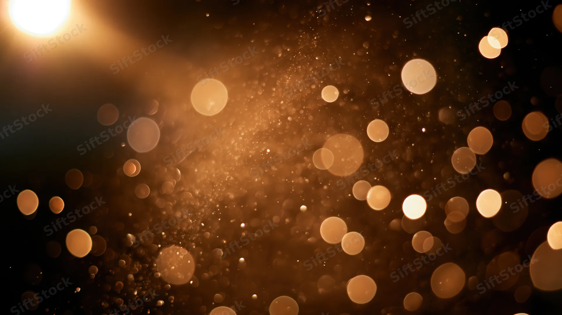 Golden bokeh lights with sparkling particles