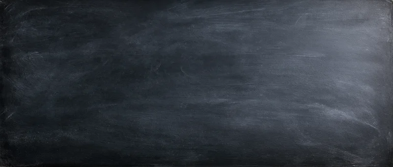 Dark chalkboard surface with smudged chalk marks and even texture, showing horizontal strokes and subtle gradient across the frame