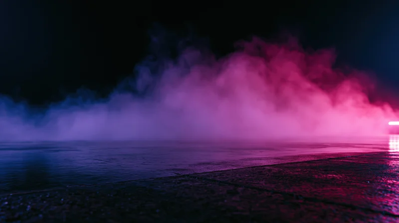 Neon-lit smoke billowing over wet pavement at night