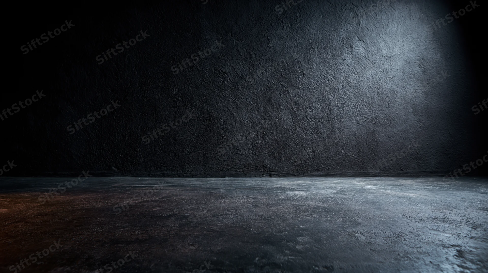 Dark textured concrete floor and wall in empty industrial studio space with spotlight and shadow