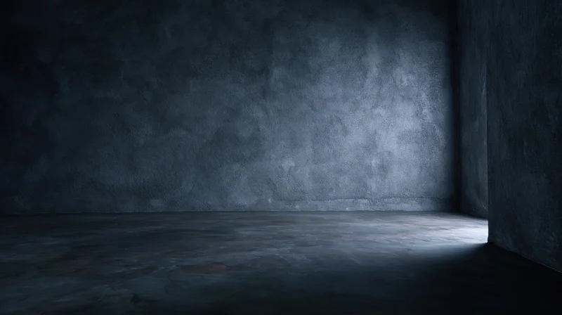 Empty concrete room with spotlight on corner floor and dark walls