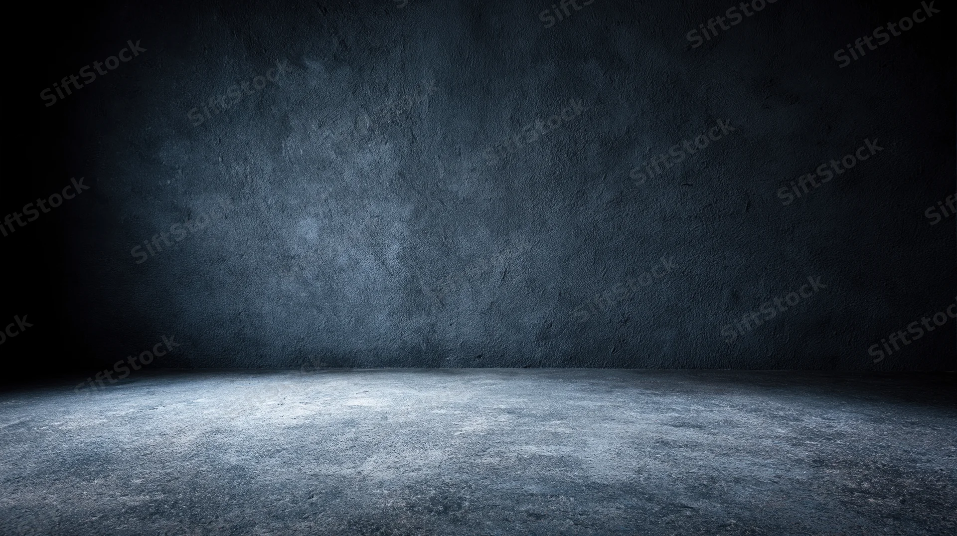 Empty concrete room with spotlight on floor and dark textured walls