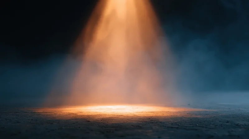 Spotlight beam illuminating a smoky floor in a dark venue