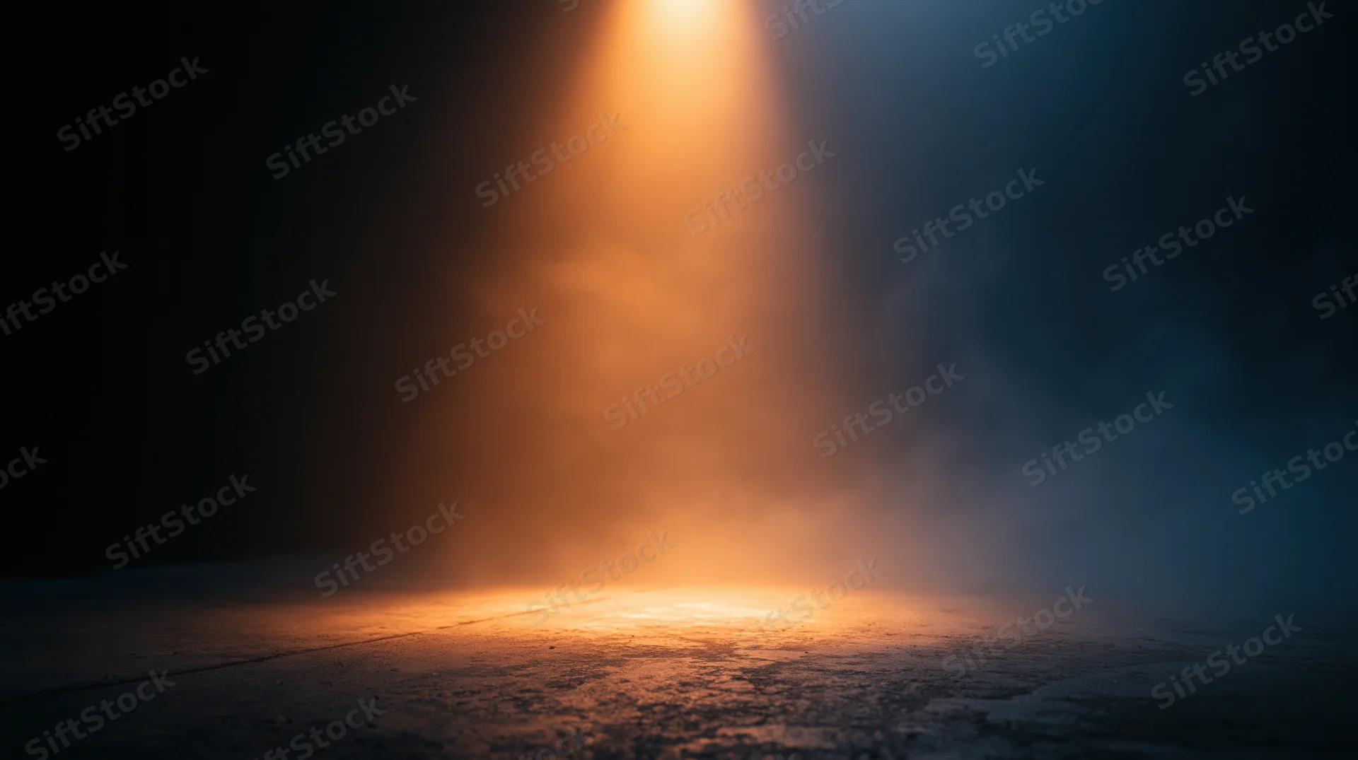 A spotlight beam illuminates a smoky stage floor in a dark theater setting