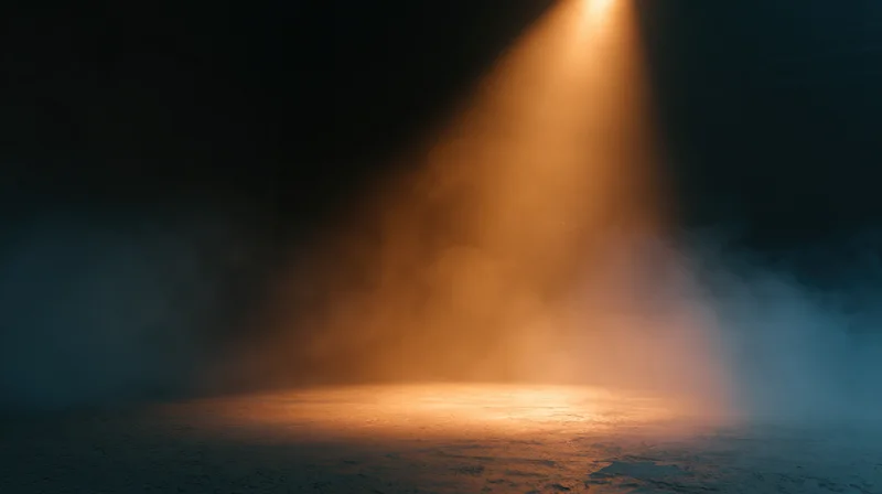 Spotlight beam cutting through smoke on a dark stage floor