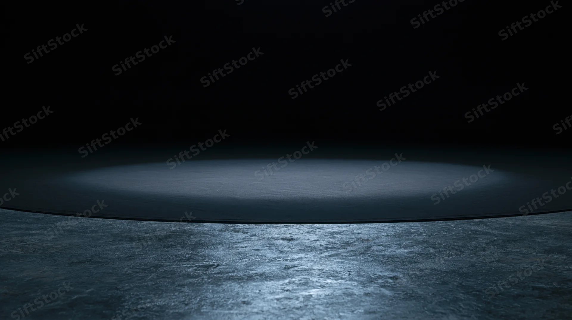 Circular spotlight on dark concrete floor in empty stage setting