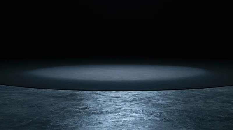 Circular spotlight on dark concrete floor in empty stage setting